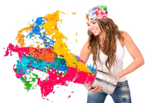 Woman splashing colorful paint from a can - isolated over white